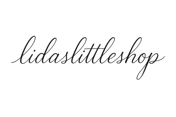 write “lidaslittleshop” in cursive with no background 